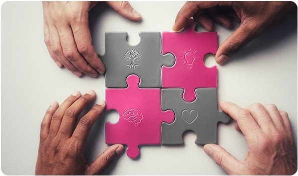 People working together with interlocking puzzle pieces